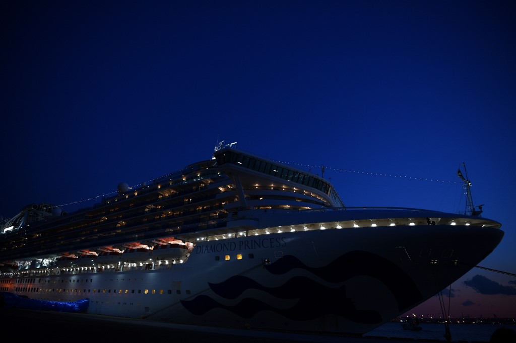 A general view shows the Diamond Princess cruise ship, with around 3,600 people quarantined onboard due to fears of the new coronavirus, at the Daikoku Pier Cruise Terminal in Yokohama port on February 10, 2020. - Around 60 more people on board the quarantined Diamond Princess cruise ship moored off Japan have been diagnosed with novel coronavirus, the country's national broadcaster said on February 10, raising the number of infected passengers and crew to around 130. (Photo by CHARLY TRIBALLEAU / AFP)